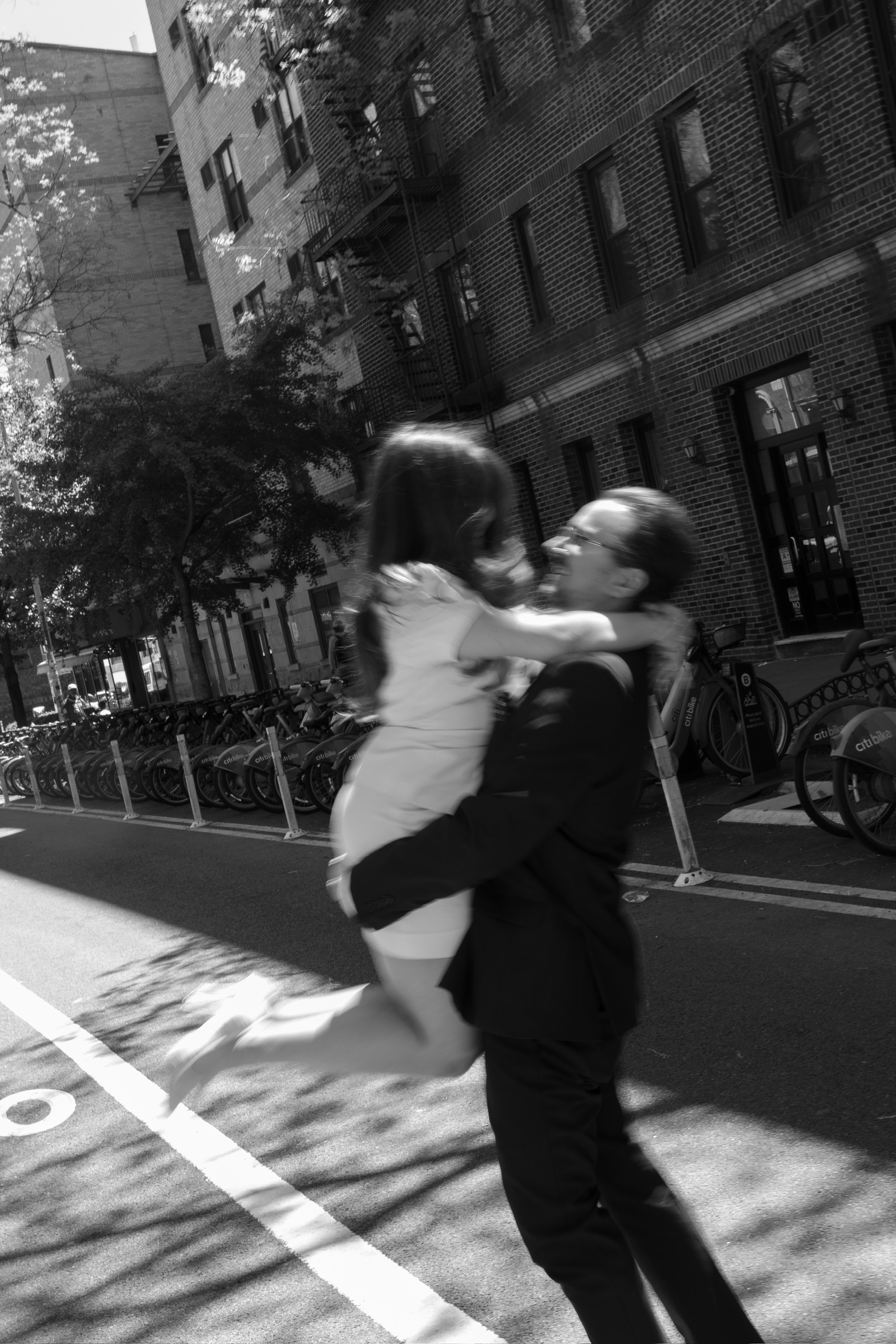 Heather and Josef caught mid-embrace on a city street